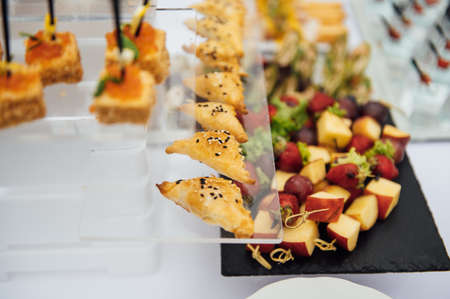 Sandwiches, canapes and cakes on the festive table. A wide variety of snacksの写真素材