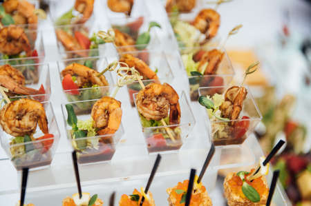 Sandwiches, canapes and cakes on the festive table. A wide variety of snacksの写真素材