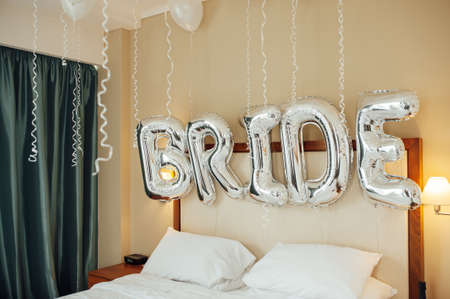 Perfect decor for the brides morning. Bed is decorated with white balloons.の写真素材