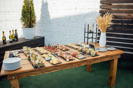 Buffet table of reception with cold snacks, meat and saladsの写真素材