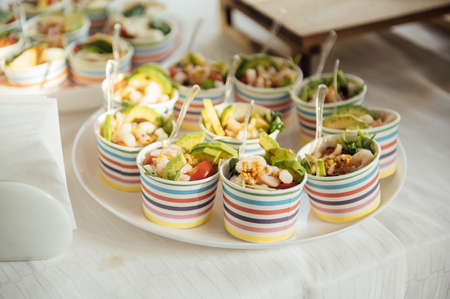 Buffet table of reception with cold snacks, meat and saladsの写真素材