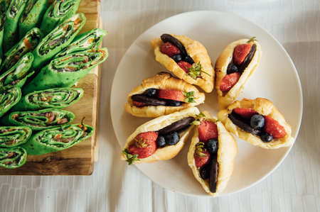 Buffet table of reception with cold snacks, meat and saladsの写真素材