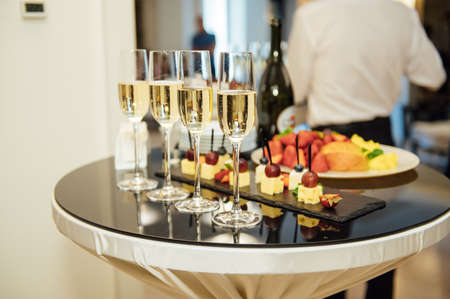 glasses with champagne and fruits on buffet table at a restaurant or in the hotel lobby