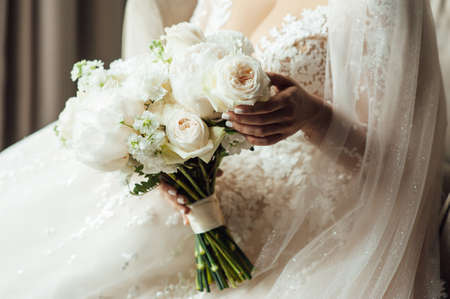 Beautiful wedding bouquet in hands of the brideの写真素材