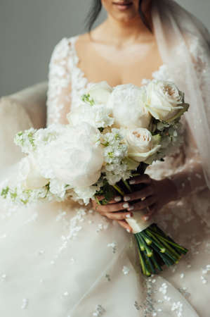 Beautiful wedding bouquet in hands of the brideの写真素材