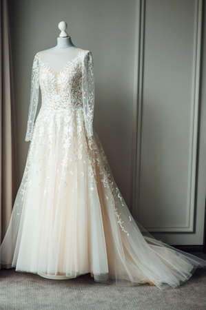Chic wedding dress is worn on a mannequin. The bride is ready to wear itの写真素材