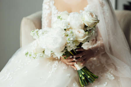 Beautiful wedding bouquet in hands of the brideの写真素材