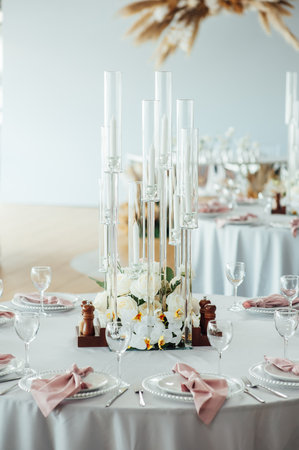 Luxurious restaurant. Luxurious interior, white tables, serving dishes and glasses for guestsの写真素材