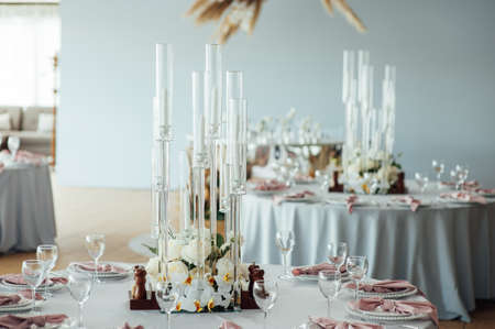 Luxurious restaurant. Luxurious interior, white tables, serving dishes and glasses for guestsの写真素材