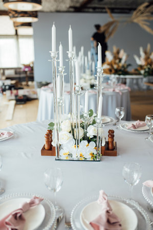 Luxurious restaurant. Luxurious interior, white tables, serving dishes and glasses for guestsの写真素材