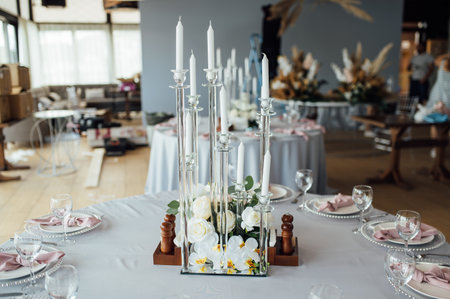 Luxurious restaurant. Luxurious interior, white tables, serving dishes and glasses for guestsの写真素材