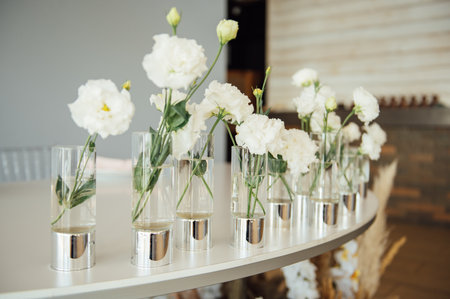 Luxurious restaurant. Luxurious interior, white tables, serving dishes and glasses for guestsの写真素材