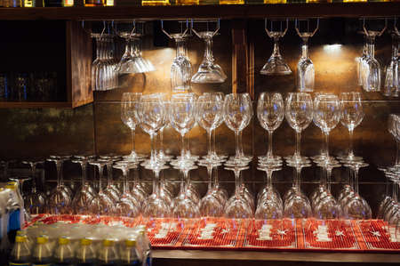 Lots of different glasses on the bar in a luxury restaurantの写真素材