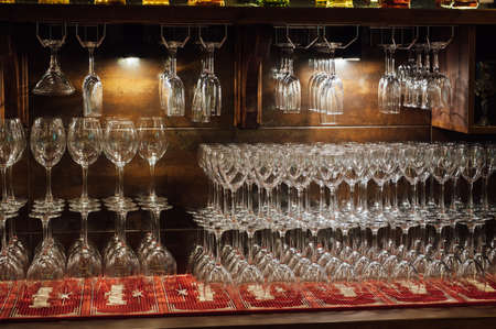 Lots of different glasses on the bar in a luxury restaurantの写真素材
