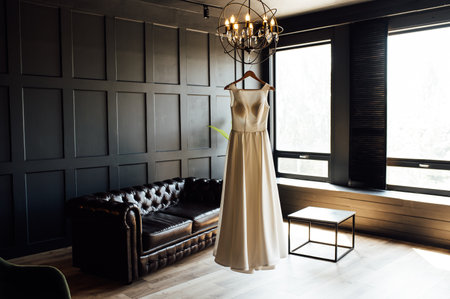 White dress of the bride before the wedding. It is located in a dark roomの写真素材
