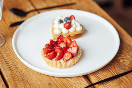 Fresh healthy breakfast in bed with cookies and strawberriesの写真素材