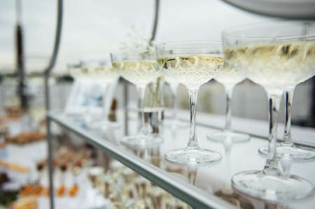 Glasses of champagne at the Banquet, white sparkling wine in wine glasses, festive moodの写真素材