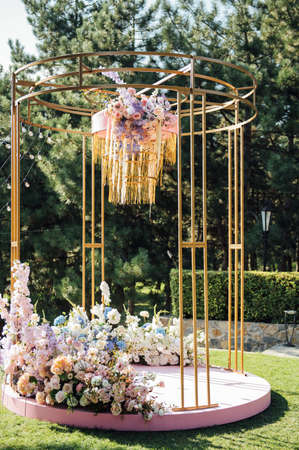 Trendy arch for a wedding ceremony with soft puffs for guestsの写真素材