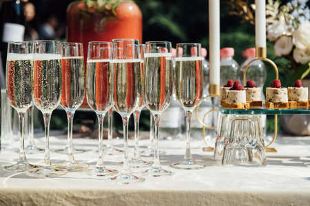 Wine glass background. Alcohol banquet table. Shiny alcohol empty glasses.の写真素材