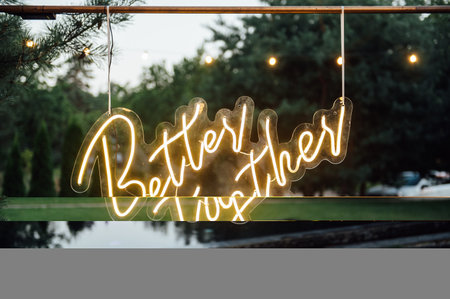 neon sign with the inscription in the garden. In the background grass and treesの写真素材