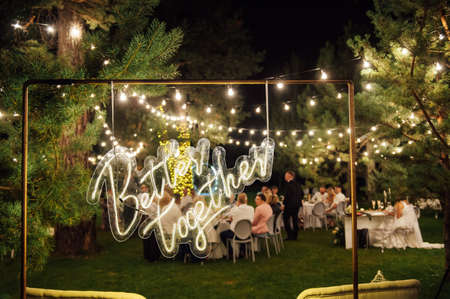 neon sign with the inscription in the garden. In the background grass and treesの写真素材