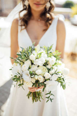 bride holding bouquet of roses, berries and eustomaの写真素材