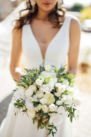 bride holding bouquet of roses, berries and eustomaの写真素材