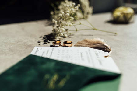 Bridal bouquet and wedding rings on windowの写真素材