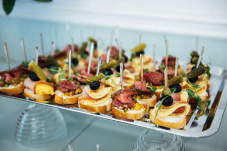 A wide variety of snacks on the table for guests. Shrimp, boiled pork, various types of meat and other productsの写真素材