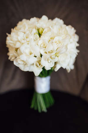 wedding bouquet of peonies lying on the chairの写真素材