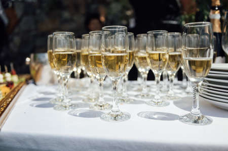 Glasses of champagne at the Banquet, white sparkling wine in wine glasses, festive moodの写真素材