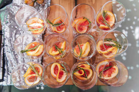 Large table with snacks of different types at a party with creative disco lighting.の写真素材