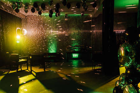 The disco ball mirror spins and reflects the light at the disco in the club.の写真素材