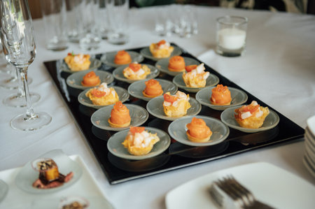 A wide variety of snacks on the table for guests. Shrimp, boiled pork, various types of meat and...