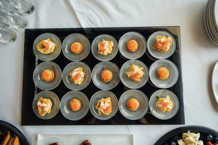 A wide variety of snacks on the table for guests. Shrimp, boiled pork, various types of meat and other productsの写真素材