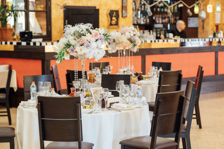 A beautiful vase of flowers on a table in a luxury restaurant. Wedding decorationsの写真素材