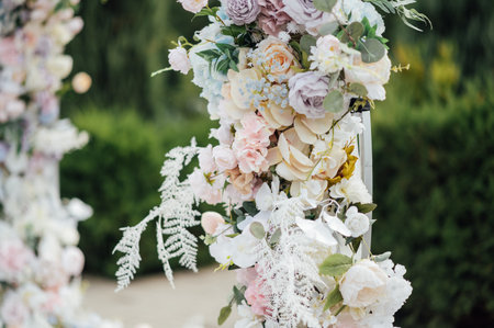 Close view of flowers in a wedding arch at an outdoor ceremony