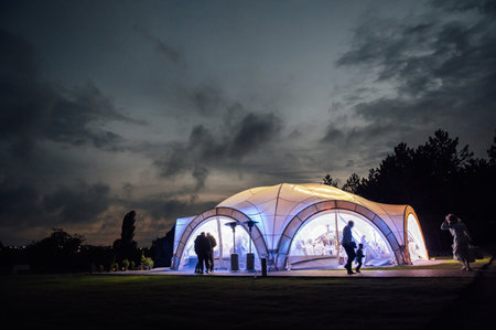 Large wedding tent in the open area for receiving guests. Evening photo with a beautiful sunsetの写真素材