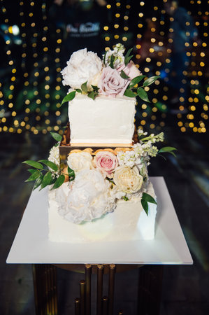 Large square wedding cake with three floors. Against the backdrop of led lighting. Premium wedding in Ukraineの写真素材