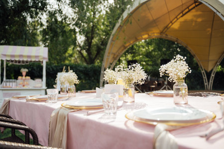 On the table is a decorative vase with dried flowers. Beautiful summer location for relaxationの写真素材