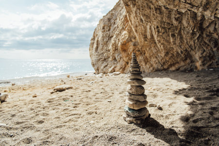 Pyramid of Serenity made of stones on the beach of the mediterranean sea on the island of Crete, Greece.の写真素材