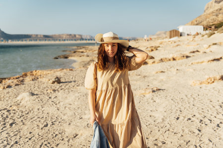 Beautiful sexy girl walks and poses for a photo on the island of Crete near Balos bayの写真素材