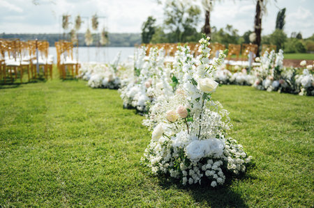 Premium arch for wedding ceremony for newlyweds on the river bank with wisteria treesの写真素材