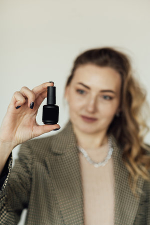 Woman nails master demonstrates new modern nail polishの写真素材