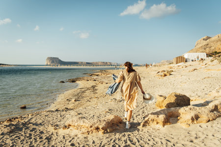Beautiful sexy girl walks and poses for a photo on the island of Crete near Balos bayの写真素材