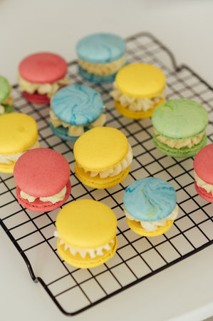 traditional french colorful macarons in a rows on a metal meshの写真素材