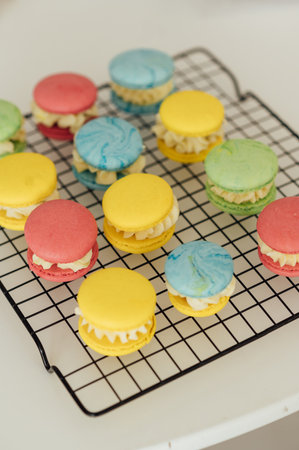 traditional french colorful macarons in a rows on a metal meshの写真素材
