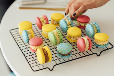 traditional french colorful macarons in a rows on a metal meshの写真素材
