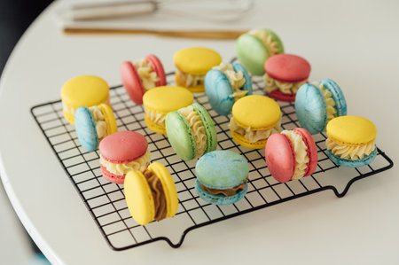 traditional french colorful macarons in a rows on a metal meshの写真素材