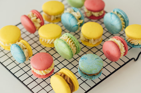 traditional french colorful macarons in a rows on a metal meshの写真素材